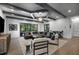 Bright living room featuring coffered ceilings, recessed lights, hardwood floors, and a comfortable sectional couch at 306 Pinecrest Ne Rd, Atlanta, GA 30342