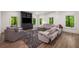 Bright living room with a large sectional, modern entertainment center, and hardwood floors at 306 Pinecrest Ne Rd, Atlanta, GA 30342
