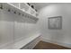 A mudroom with hooks, storage, bench, and light wood floors at 306 Pinecrest Ne Rd, Atlanta, GA 30342