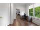 Bright office features a modern desk, hardwood floors, and a view of the outdoors through a large window at 306 Pinecrest Ne Rd, Atlanta, GA 30342