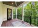A covered patio with black framed glass door and wooded view at 306 Pinecrest Ne Rd, Atlanta, GA 30342