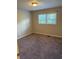 Comfortable bedroom with neutral carpet, neutral paint, and a window offering plenty of natural light at 3990 N Quail Dr, Douglasville, GA 30135