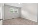 This bedroom features neutral walls, carpet, a window, and a ceiling light at 3990 N Quail Dr, Douglasville, GA 30135