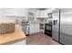 Bright kitchen with stainless steel appliances, butcher block counters, and white cabinets at 3990 N Quail Dr, Douglasville, GA 30135