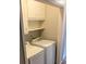 Convenient laundry room with full-sized washer and dryer, upper cabinets, and shelving for storage at 3990 N Quail Dr, Douglasville, GA 30135