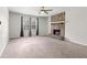 Spacious living room with a stone fireplace, a ceiling fan, and lots of natural light at 3990 N Quail Dr, Douglasville, GA 30135