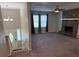 Inviting living room with a stone fireplace, neutral paint, large windows, and new ceiling fan at 3990 N Quail Dr, Douglasville, GA 30135