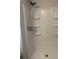 Modern shower with multi-tier shelving, offering plenty of storage space and adjustable shower head at 3990 N Quail Dr, Douglasville, GA 30135