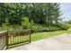 Backyard patio with a wooden railing overlooking the grass yard with mature trees beyond at 808 Plaintain Dr, Woodstock, GA 30188