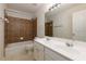Bathroom featuring double sink vanity and shower-tub combo at 808 Plaintain Dr, Woodstock, GA 30188