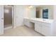 Bathroom featuring double sink vanity, standup shower, and ample storage at 808 Plaintain Dr, Woodstock, GA 30188