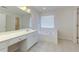 Bright bathroom featuring double sink vanity and separate bathtub at 808 Plaintain Dr, Woodstock, GA 30188