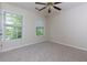A bright carpeted bedroom with two large windows allowing plenty of natural light in at 808 Plaintain Dr, Woodstock, GA 30188