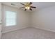 Bedroom with neutral carpeting, ceiling fan, and a large window at 808 Plaintain Dr, Woodstock, GA 30188