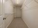 Walk-in closet with wire shelving and neutral carpeting at 808 Plaintain Dr, Woodstock, GA 30188
