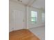 Entryway featuring hardwood floors with views into the living room and large windows at 808 Plaintain Dr, Woodstock, GA 30188