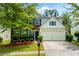 Charming two-story home featuring a well-manicured lawn, mature trees, and a two-car garage at 808 Plaintain Dr, Woodstock, GA 30188