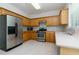 Traditional kitchen with wooden cabinets, stainless steel appliances, and neutral countertops at 808 Plaintain Dr, Woodstock, GA 30188