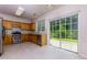 Well-appointed kitchen featuring modern appliances, backsplash and sliding glass doors to the backyard at 808 Plaintain Dr, Woodstock, GA 30188