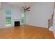 Living room featuring hardwood floors, fireplace, ceiling fan, and plenty of natural light at 808 Plaintain Dr, Woodstock, GA 30188