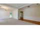 Bright living room features carpet, wood floor accents, and views of the backyard at 808 Plaintain Dr, Woodstock, GA 30188