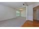 Spacious living room with plush carpet, columns, large windows and a view into the dining area at 808 Plaintain Dr, Woodstock, GA 30188