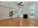 Bright and spacious living room with hardwood floors, fireplace, and connected to the kitchen at 808 Plaintain Dr, Woodstock, GA 30188