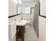 Cozy bathroom featuring a classic black and white tile floor, a sink with under cabinet and shower at 861 Marion Se Ave, Atlanta, GA 30312