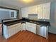 Well-appointed kitchen with stainless steel dishwasher, black countertops, and white cabinetry offering style and functionality at 861 Marion Se Ave, Atlanta, GA 30312