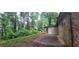 Landscaped backyard with a concrete patio and mature trees at 2035 Northland Dr, Lawrenceville, GA 30044