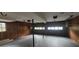 Unfinished basement featuring concrete floors, wood paneling, and a garage door at 2035 Northland Dr, Lawrenceville, GA 30044