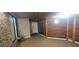 Carpeted basement with wood paneling, brick accents, and a sliding glass door at 2035 Northland Dr, Lawrenceville, GA 30044