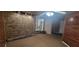 Basement featuring carpet, brick accents, wood paneling, and a sliding glass door at 2035 Northland Dr, Lawrenceville, GA 30044
