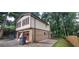 Two-story home featuring a brick and siding exterior, garage, and mature trees at 2035 Northland Dr, Lawrenceville, GA 30044