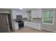 Bright kitchen featuring stainless steel appliances and modern white cabinetry at 2035 Northland Dr, Lawrenceville, GA 30044
