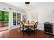 Elegant dining room with hardwood floors, stylish lighting, backyard view, and an adjacent wine cooler at 2343 Limehurst Ne Dr, Atlanta, GA 30319