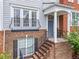 Charming townhome entrance with brick stairs, black railings, and a covered porch at 2343 Limehurst Ne Dr, Atlanta, GA 30319