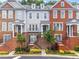 Townhome exteriors with brick and gray siding, featuring manicured landscaping and inviting entrances at 2343 Limehurst Ne Dr, Atlanta, GA 30319