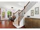 Foyer with staircase, hardwood floors, adjacent dining room, and decorative cabinet at 2343 Limehurst Ne Dr, Atlanta, GA 30319
