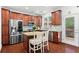 Kitchen featuring stainless steel appliances, wood cabinets, granite countertops, and adjacent island seating at 2343 Limehurst Ne Dr, Atlanta, GA 30319