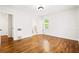 This bedroom features hardwood floors and glimpses into the bathroom and the hallway at 3211 Hollydale Drive Sw, Atlanta, GA 30311