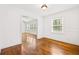 Bright dining room showcasing hardwood floors, white walls, and seamless access to the living room at 3211 Hollydale Drive Sw, Atlanta, GA 30311