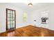 Dining space with hardwood floors leading to kitchen with white cabinetry and stainless steel appliances at 3211 Hollydale Drive Sw, Atlanta, GA 30311