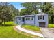 Charming home featuring a blue painted brick exterior, well-manicured lawn, and an attached one-car garage at 3211 Hollydale Drive Sw, Atlanta, GA 30311