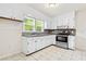 Bright kitchen features white cabinets, a window, and stainless steel appliances at 3211 Hollydale Drive Sw, Atlanta, GA 30311