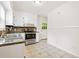 View of the kitchen featuring white cabinets, granite countertops, and stainless steel appliances at 3211 Hollydale Drive Sw, Atlanta, GA 30311