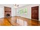 Spacious living room with hardwood floors, a brick fireplace, and ample natural light at 3211 Hollydale Drive Sw, Atlanta, GA 30311