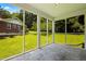 Enclosed sunroom with screens and a view of the grassy backyard and trees at 3211 Hollydale Drive Sw, Atlanta, GA 30311