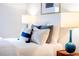 A close-up shows a beautifully styled bed with layered pillows and a stylish table lamp at 620 Glen Iris Dr # 223, Atlanta, GA 30308