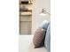 Bedroom showing a walk-in closet with shelving and storage, and a neatly made bed with several pillows at 620 Glen Iris Dr # 223, Atlanta, GA 30308